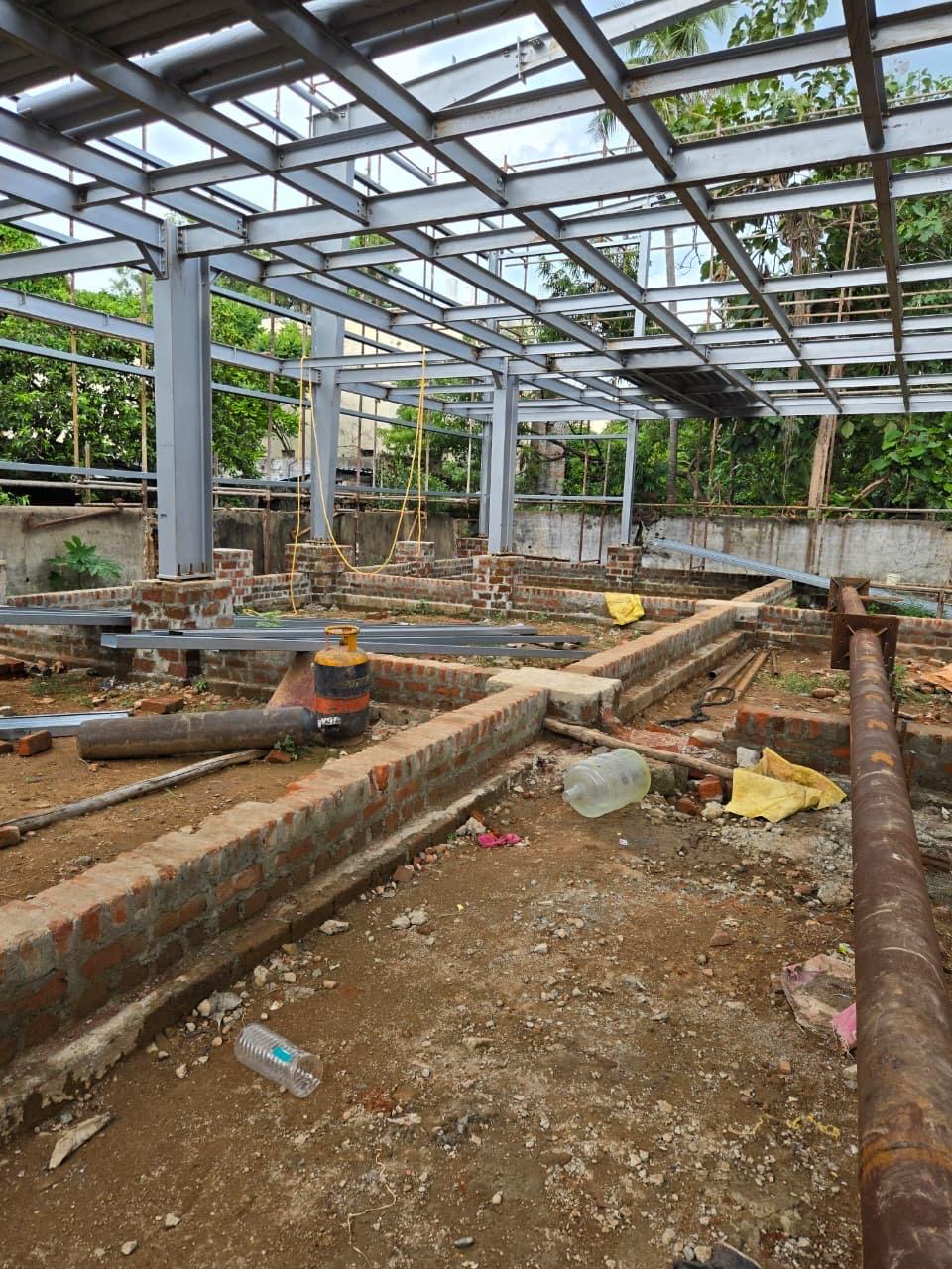 Foundation plinths, base anchor plates, and roof truss framework